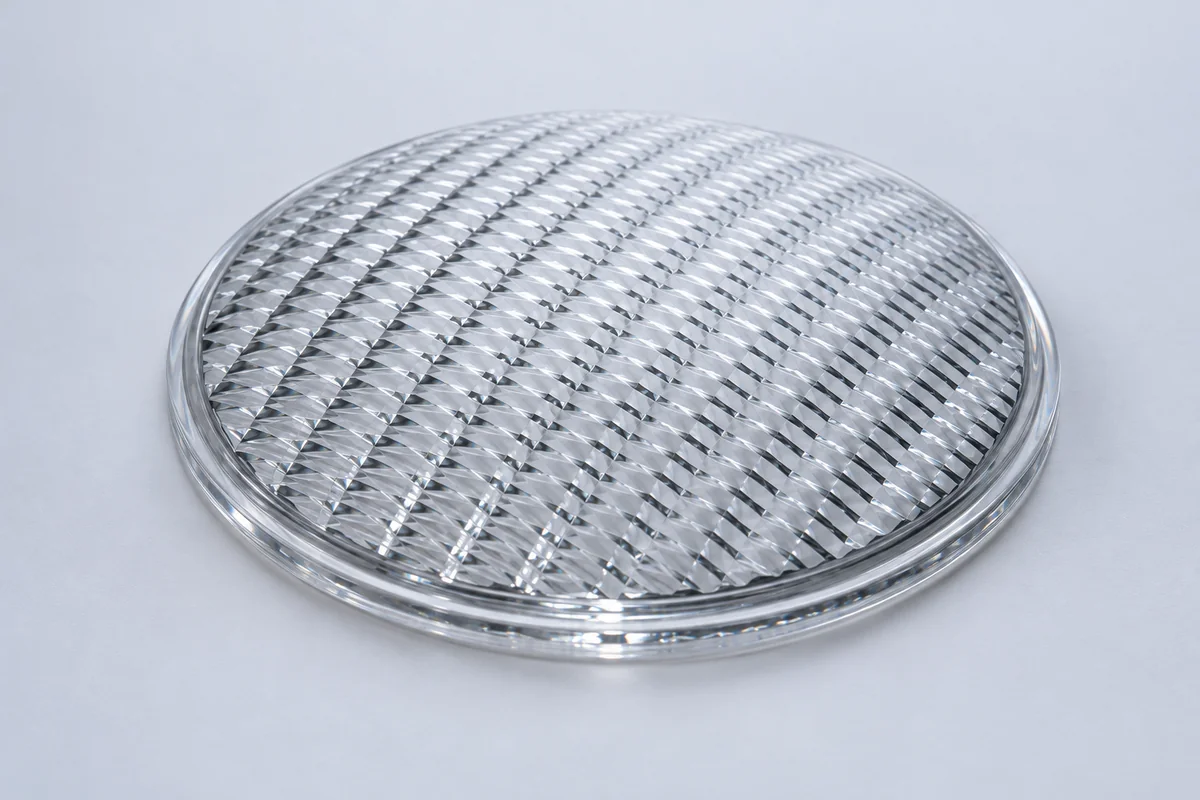 Pressed patterned glass lens and molded optical surface